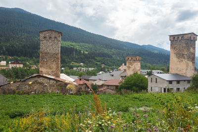 Old building by mountains against sky