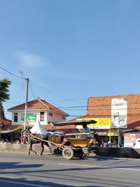 Vehicles on road against buildings