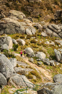 Man standing on cliff against mountains