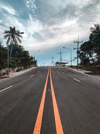 Road leading towards city against sky