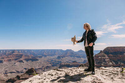 Man standing on landscape against sky