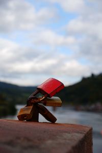 Close-up of rusty metallic toy against sky