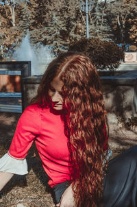 Portrait of young woman sitting outdoors