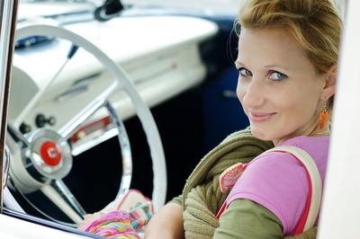 Portrait of smiling woman in car