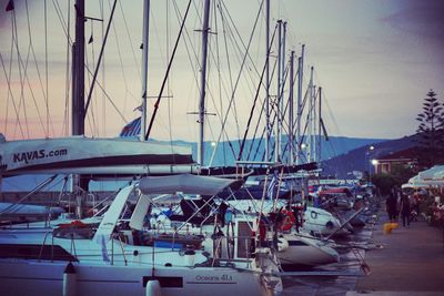 Sailboats moored at harbor