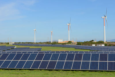 Solar panels on field against sky