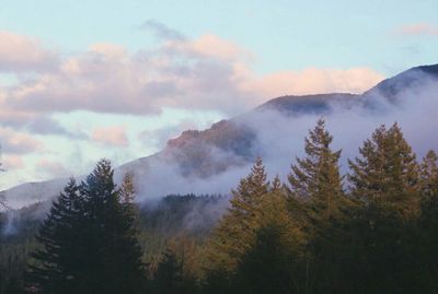 Scenic view of mountains against cloudy sky