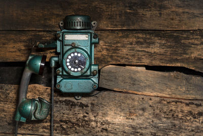 Old vintage sity telephone on an old wooden wall for use in a mine