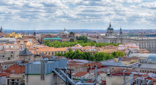 View of the buildings of the city on a sunny day. real palace at the bottom. madrid, spain