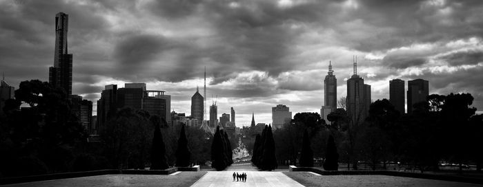 Cityscape against cloudy sky