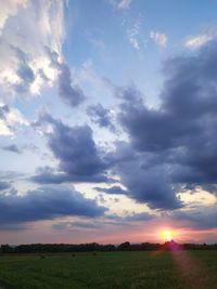 Scenic view of field against sky during sunset