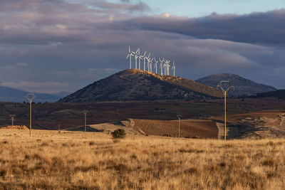 Windmill on field against sky