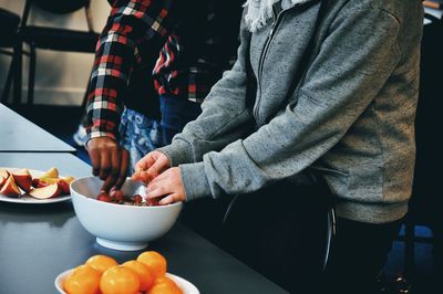 Close-up of man preparing food on table