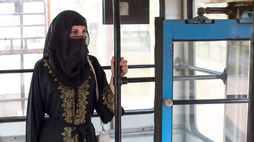 Muslim woman public transport going to work. person