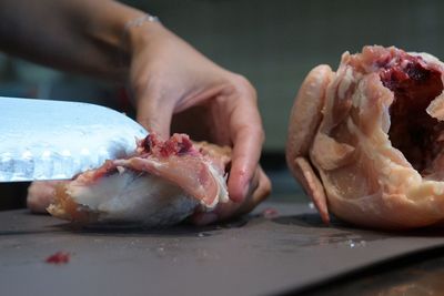 Close-up of man preparing food on cutting board