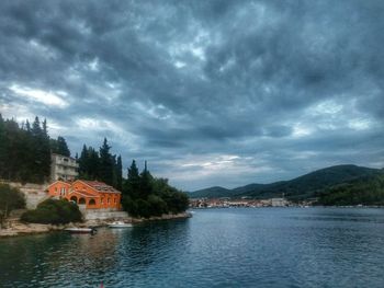 Scenic view of lake by trees against sky