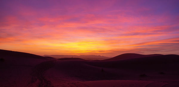 Scenic view of silhouette landscape against romantic sky at sunset