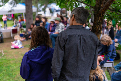 Rear view of people standing outdoors