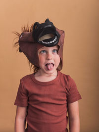 Portrait of boy wearing mask against gray background