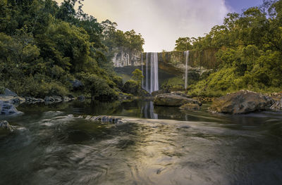 Scenic view of waterfall against sky