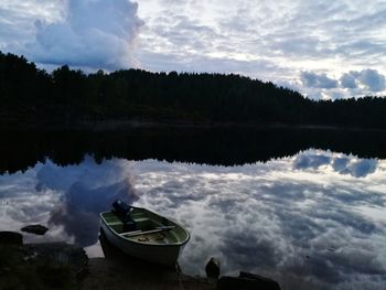 Panoramic view of boats moored in lake against sky