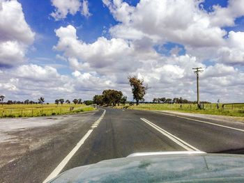 Empty road against cloudy sky