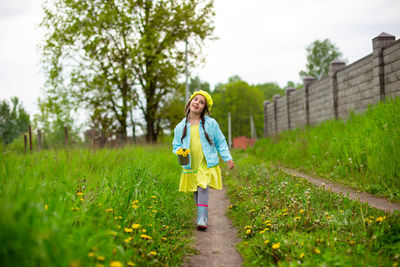 Rear view of woman walking on field