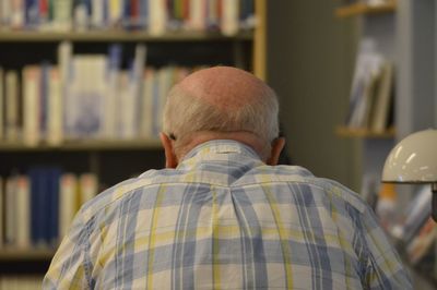 Rear view of man in library