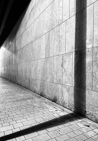 Shadow of stone wall with tiled floor
