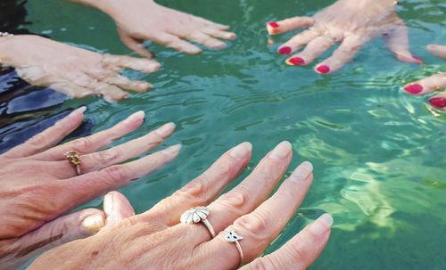 Cropped hands of woman in swimming pool