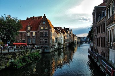 Canal amidst buildings against sky