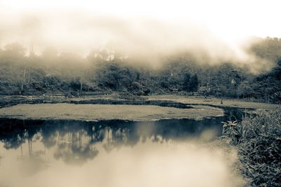 Scenic view of lake against sky during winter