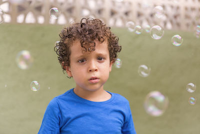 Portrait of boy blowing bubbles