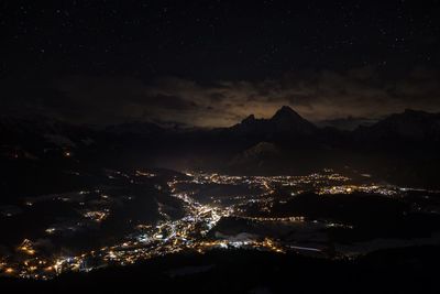 Aerial view of illuminated cityscape against sky at night