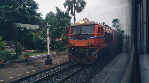 Train on railroad track against sky