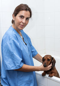 Female veterinarian examining dog in animal hospital