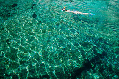 High angle view of young woman swimming in sea