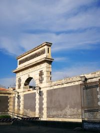 Low angle view of historical building against cloudy sky