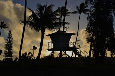 Silhouette palm trees against sky at sunset