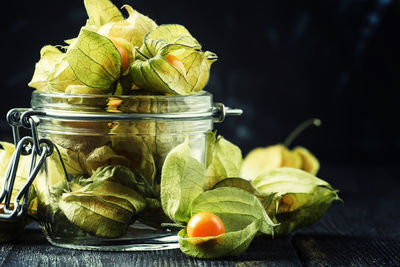 Close-up of fruits in glass jar on table