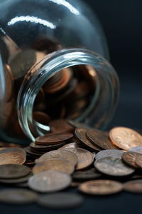 Close-up of coins in jar on table