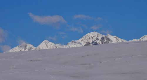 Scenic view of snowcapped mountains against sky