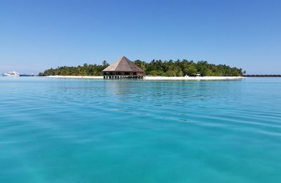 Scenic view of calm sea against clear blue sky