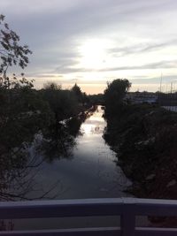 Scenic view of river against sky at sunset