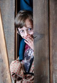 Portrait of boy with open door