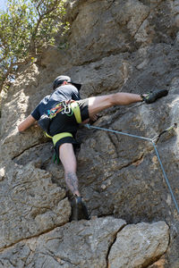 Full length rear view of man standing on rock