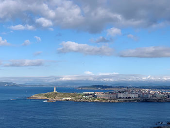 Scenic view of sea by buildings against sky