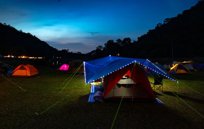 Tent on field against sky at night
