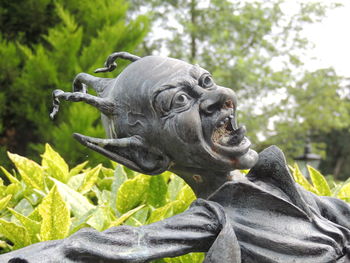 Low angle view of statue against trees in park