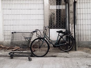 Bicycle parked against building